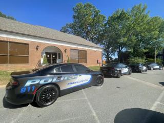 Several Franklinton Police cars parked outside of the Franklinton Town Hall.